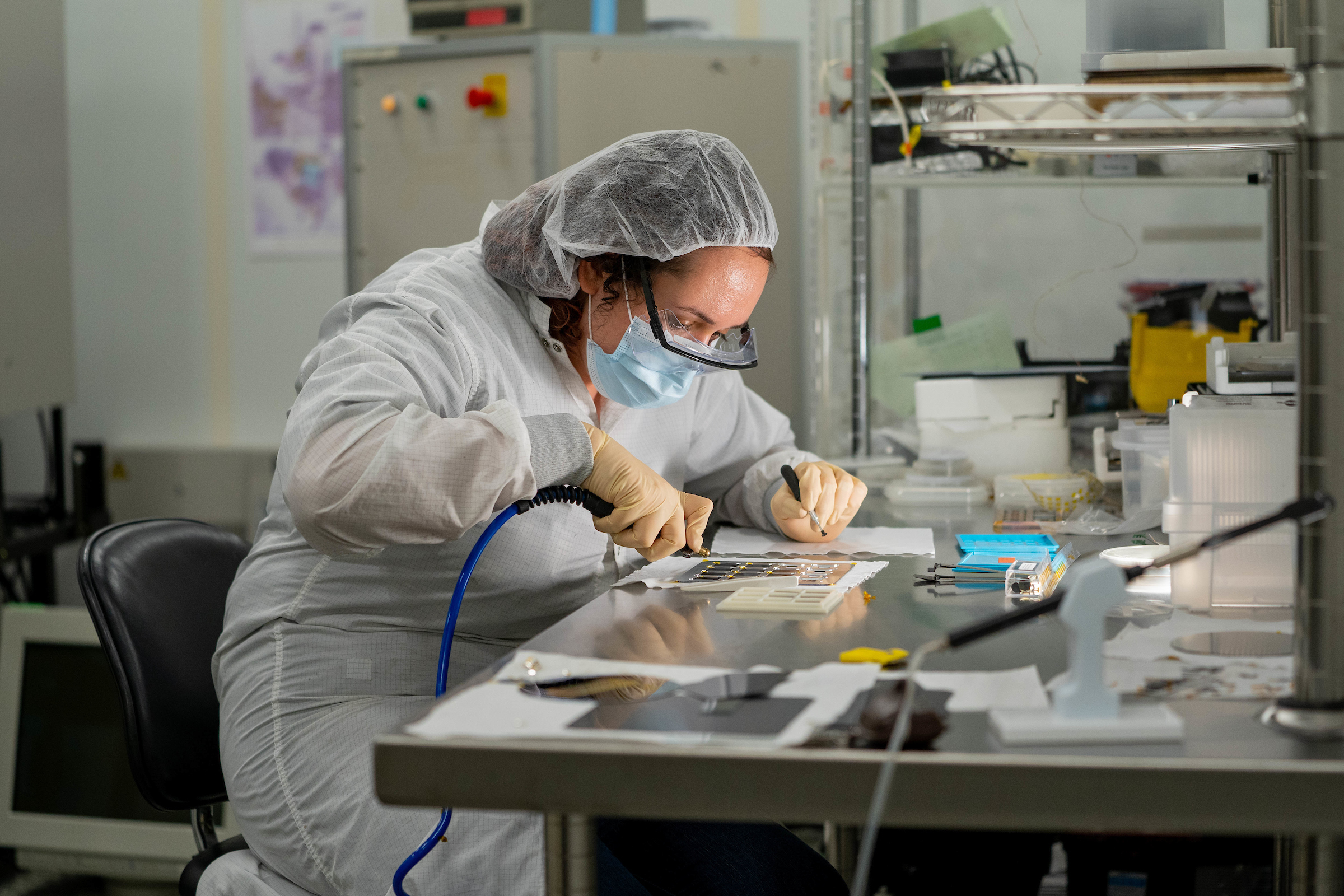 Researcher Maria Garcia works inside a research area with lasers at the MacroTechnology Works research facility in the ASU Research Park in Tempe, Ariz